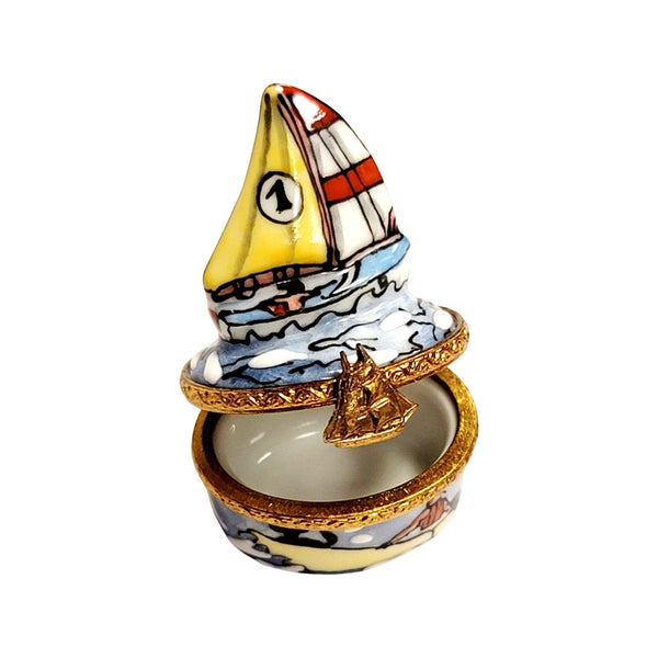 Vintage Limoges hand-painted porcelain sailboat trinket box with gold trim and colorful sails