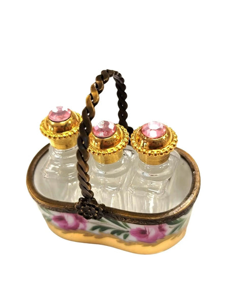 Vintage Limoges luxury French perfume bottles with gold caps and pink gems in decorative basket