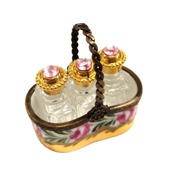 Vintage Limoges luxury French perfume bottles set with gold caps and pink jewels in floral holder